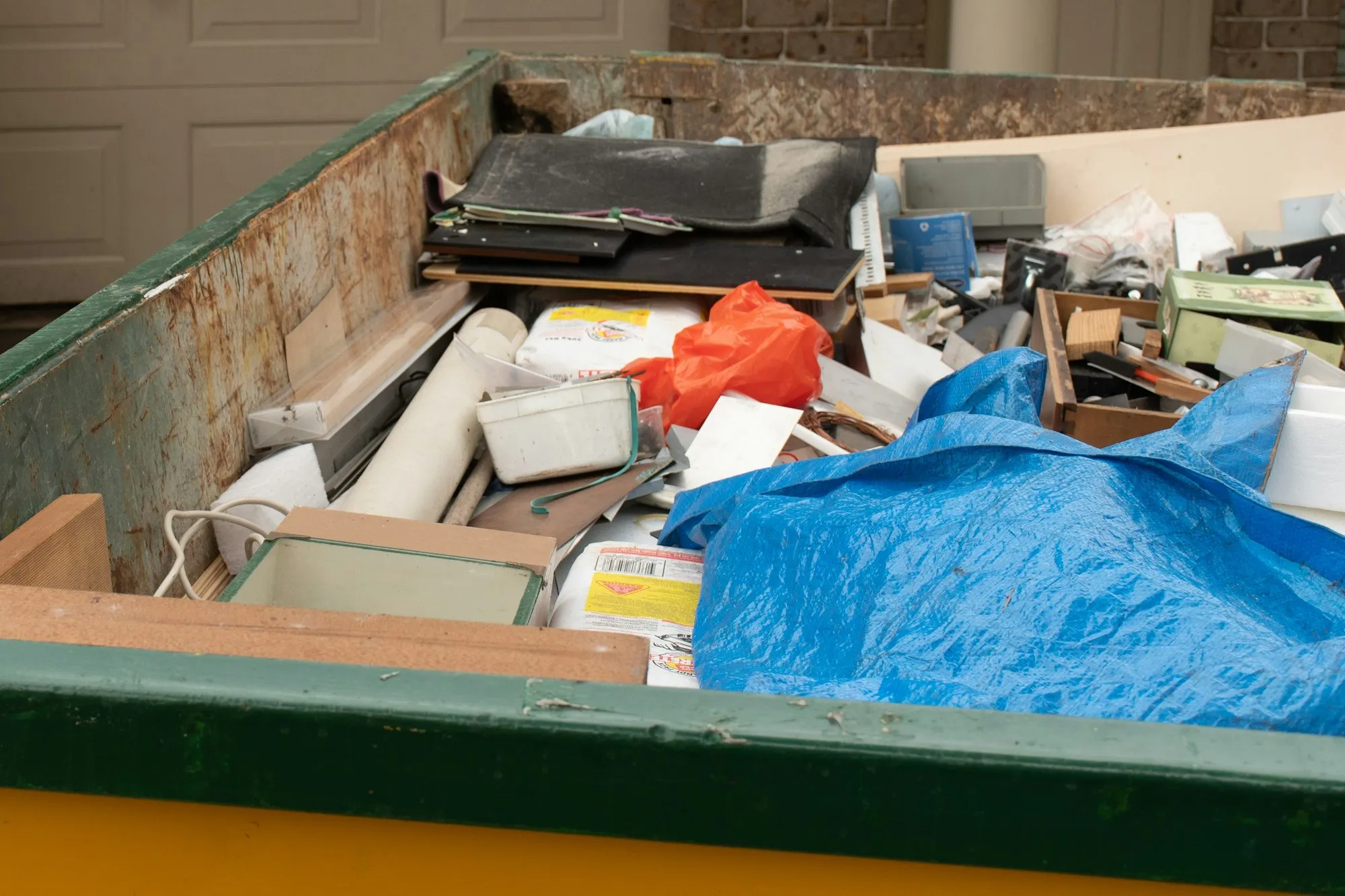 skip-bin-full-of-household-waste-rubbish-on-the-front-yard-house-clean-up