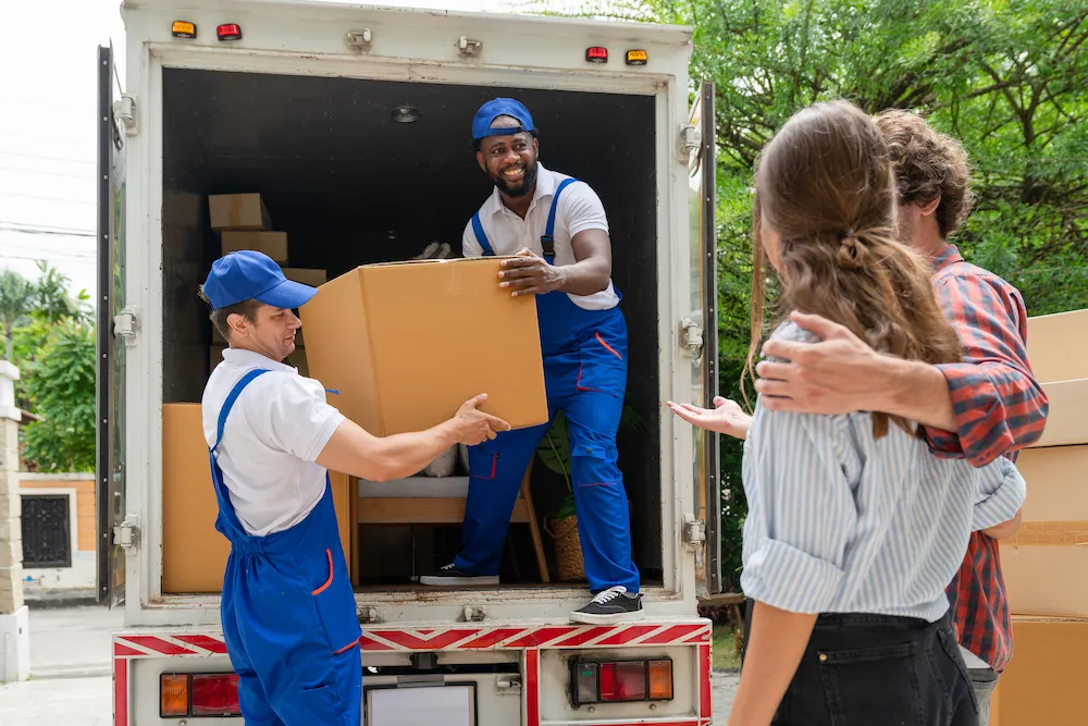 two-men-movers-in-blue-uniform-lift-cardboard-box-2023-11-27-04-51-25-utc