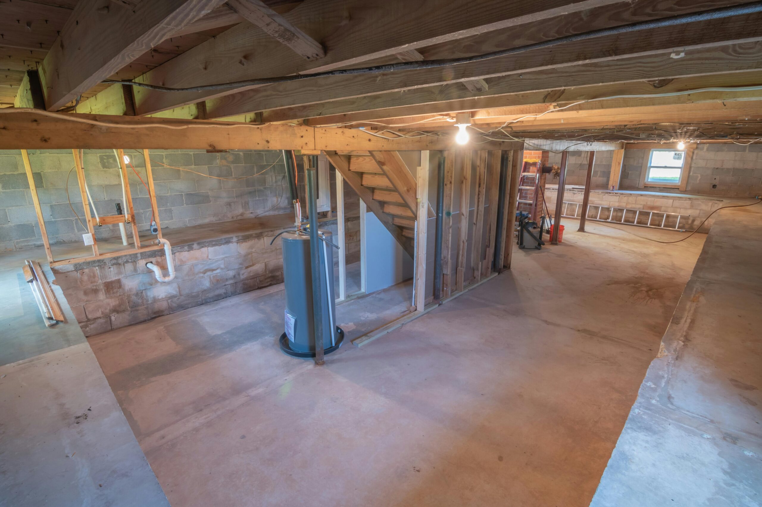 How to finish a basement showing drywall installation, flooring installation, and ceiling installation during basement renovation.
