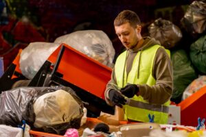Waste audit process showing sorting of household and business waste into recycling categories