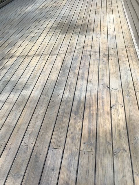 remove old wooden deck boards during backyard deck demolition project