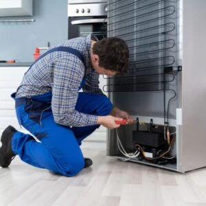 Technician removing Freon from refrigerator using professional recovery equipment during fridge disposal process